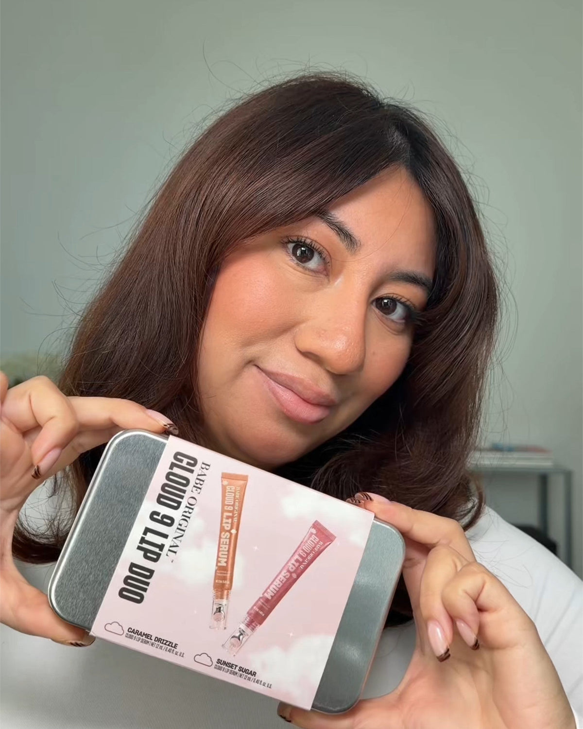 Customer holding the Cloud 9 Lip Duo holiday tin