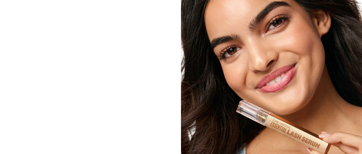Model holding Essential Lash Serum