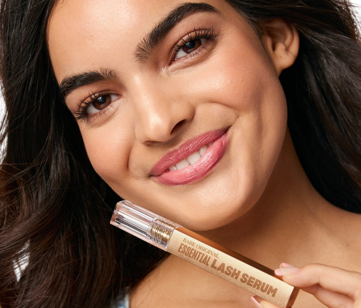 Model holding Essential Lash Serum